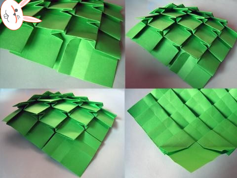 第十步然后再调节一下这个手工折纸圣诞树底部的结构，使得其看起来更加的平整，方便后面的卷起