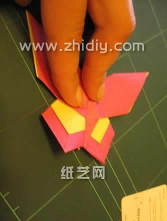 第二十九步压平整之后的手工折纸蝴蝶在造型上非常的逼真，尤其是是手工折纸蝴蝶后部的色彩结构