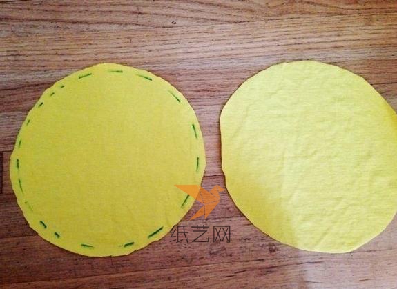 我们制作的小黄人的抱枕是圆形的，所以相对简单一些，用黄色的布料剪成两块一样大的圆形