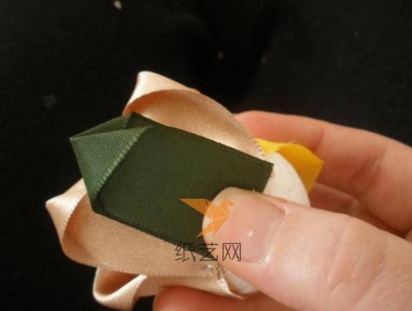 然后用绿色的丝带同样的折叠方式，固定到花瓣的下面
