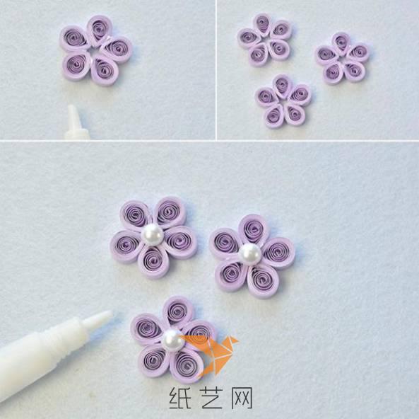 下面每五个水滴型粘成一个衍纸花朵，然后在中间加上珠子装饰，衍纸花朵就做好啦